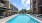 a pool outside of a building with large windows