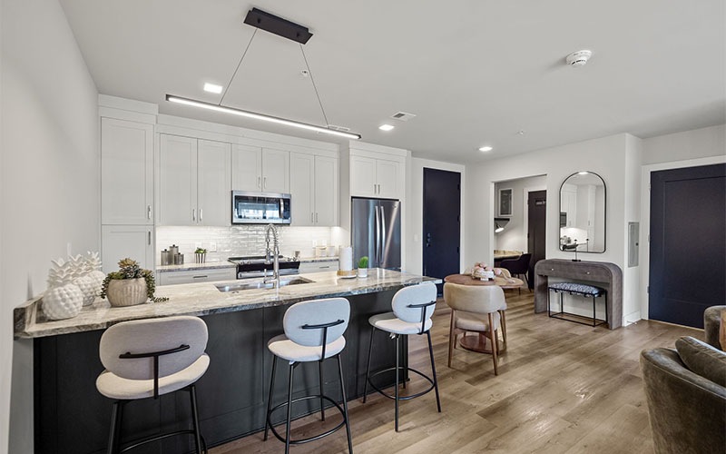 a kitchen with barstool seating