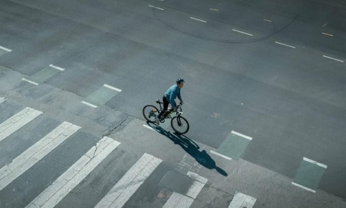 a person riding a bicycle on a street