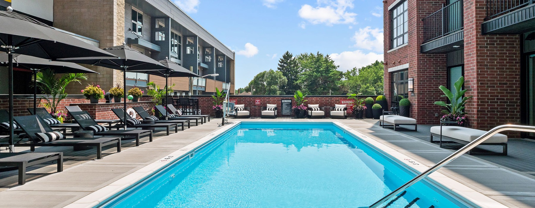 a pool with poolside seating